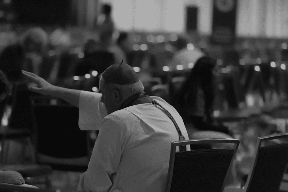 This image shows a priest giving the sacrament of Confession, a Catholic sacrament where one confesses their sins to a priest. 